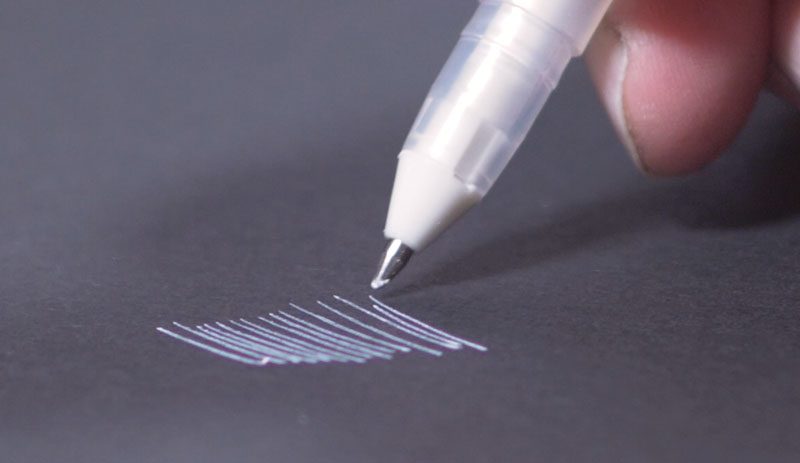 Drawing on black paper with ink